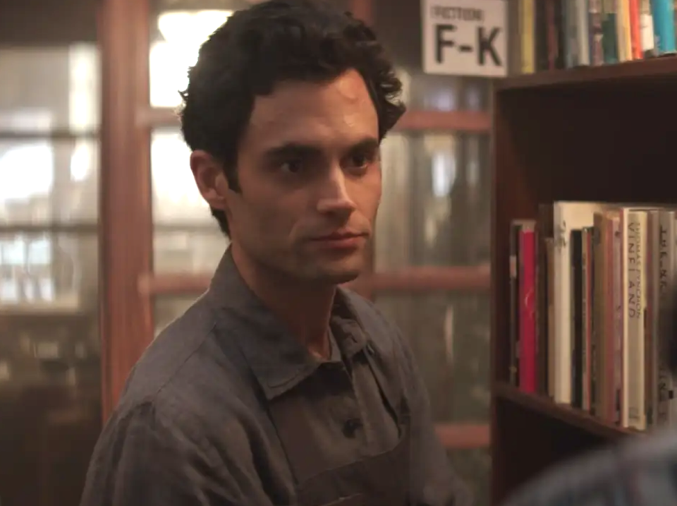 Penn Badgley in "You" in a library