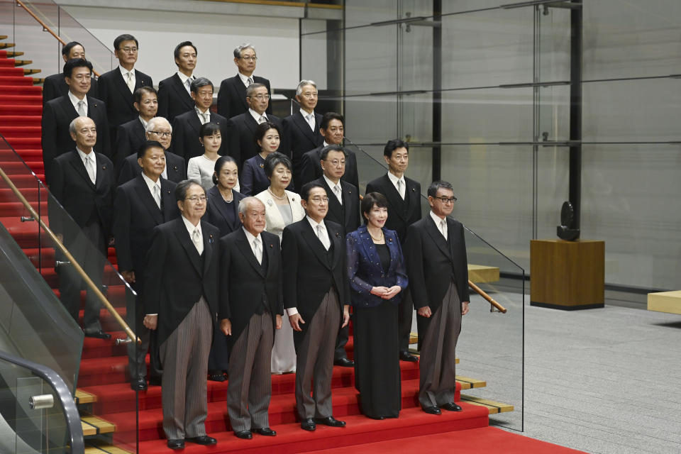 Japanese Prime Minister Fumio Kishida, center, bottom row, poses with his new cabinet members in Tokyo, Japan, Wednesday, Sept. 13, 2023, after a cabinet reshuffle. (David Mareuil/Pool Photo via AP)