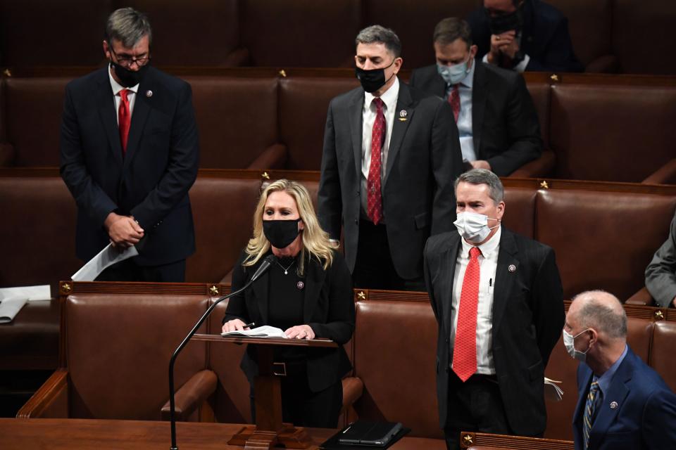 Rep. Marjorie Taylor Greene (R-GA) reads an objection to the counting of the certificate of vote from the state of Michigan during a joint session of Congress after the session resumed following a pro-Trump insurrection at the Capitol in Washington, DC, early on Jan. 7, 2021. Members of Congress returned to the House Chamber after being evacuated when rioters stormed the Capitol and disrupted a joint session to ratify President-elect Joe Biden's 306-232 Electoral College win over President Trump.