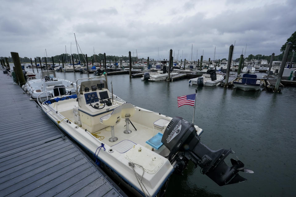 Storm clouds loom over boats docked at a marina in Branford, Conn., Sunday, Aug. 22, 2021 as Tropical Storm Henri affects the Atlantic coast. (AP Photo/Mary Altaffer)