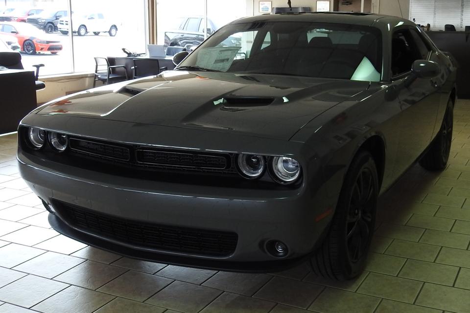 A Dodge challenger in the showroom of Jeff Drennen's dealership on Otsego Avenue. Flat colors in gray, black and white are trending with customers.