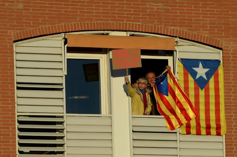 A woman holds a placard reading "I smile at the republic and cry for the prisoners" during a demonstration in Barcelona against the jailing of the region's separatist leaders