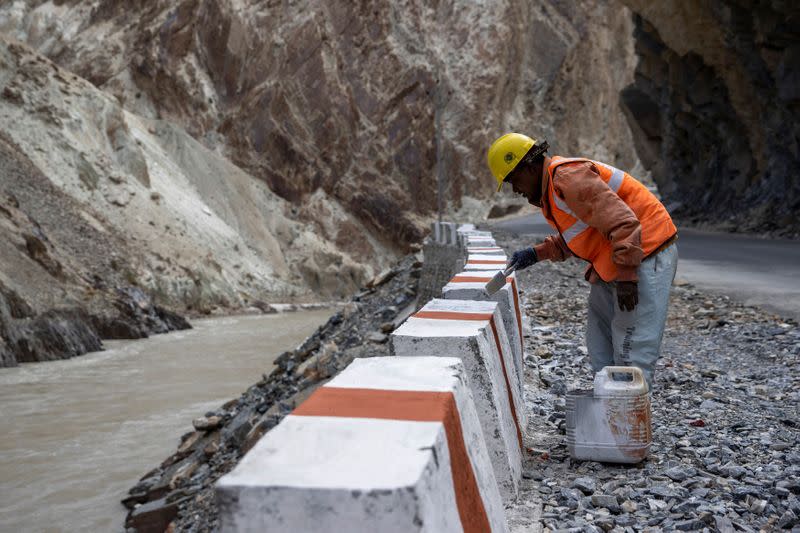 A labourer from the Border Roads Organisation (BRO) works on an under construction highway in the Ladakh region