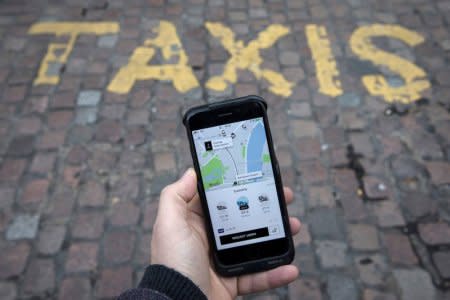 A photo illustration shows the Uber app on a mobile telephone, as it is held up for a posed photograph, in London, Britain November 10, 2017.  REUTERS/Simon Dawson