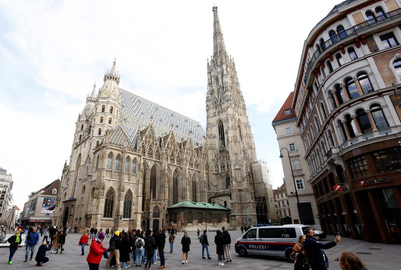 An Austrian police car passes St. Stephens cathedral in Vienna