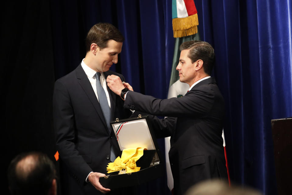 FILE - Mexican President Enrique Pena Nieto, right, decorates White House Senior Adviser Jared Kushner with Mexico's Order of the Aztec Eagle, in Buenos Aires, Argentina, Nov. 30, 2018. Donald Trump’s son-in-law received Mexico’s highest honor for helping to renegotiate the North American trade agreement. (AP Photo/Pablo Martinez Monsivais, File)