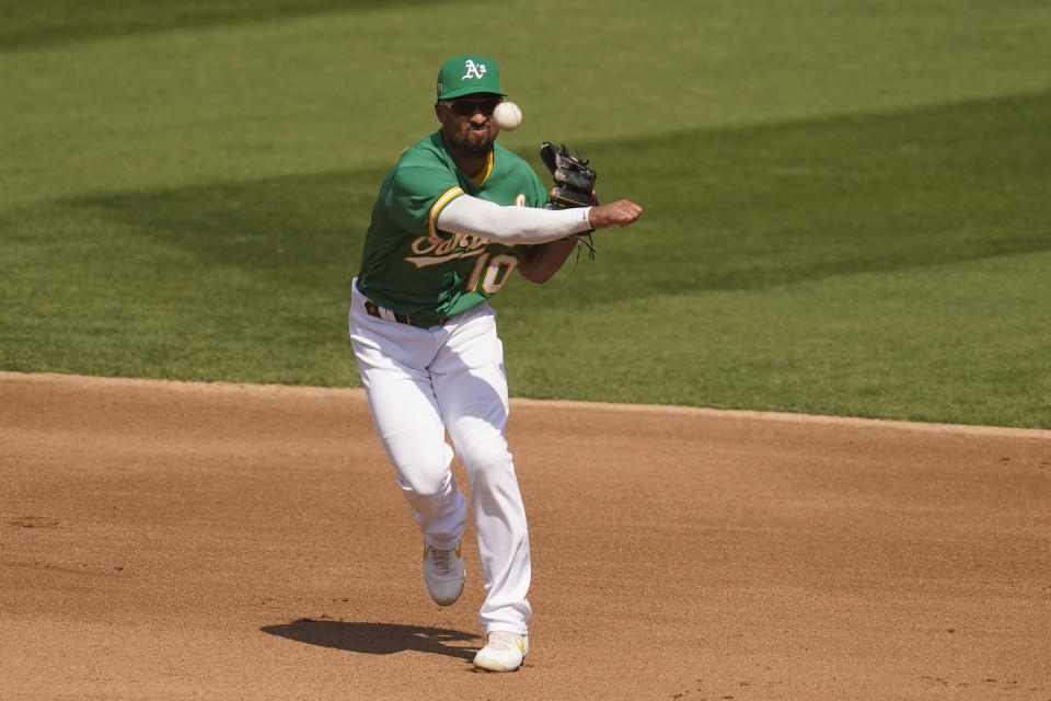 Oakland Athletics shortstop Marcus Semien throws out Chicago White Sox's Luis Robert at first base during the fourth inning of Game 2 of an American League wild-card baseball series Wednesday, Sept. 30, 2020, in Oakland, Calif. (AP Photo/Eric Risberg)