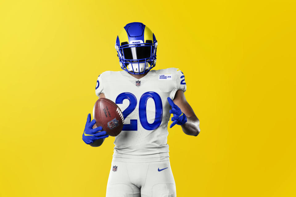 This undated graphic image released by the Los Angeles Rams NFL football team shows a model in their 'bone' uniform color scheme. The Rams have unveiled new uniforms ahead of their move into SoFi Stadium this year. (Los Angeles Rams via AP)