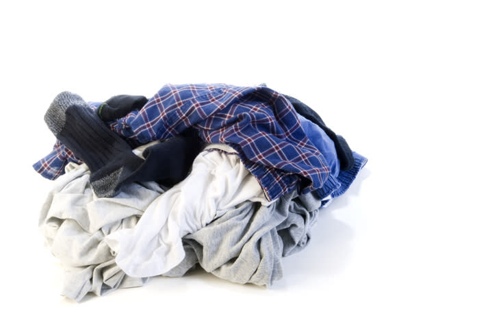 Pile of assorted men's clothing including boxers and a sock