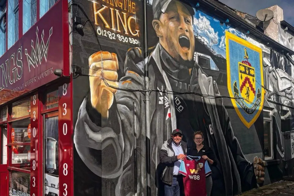 Omar Zaman and Justine Bedford, landlady of the Royal Dyche,  in front of Burnley FC mural outside Kings Taxis <i>(Image: Kings Taxis)</i>