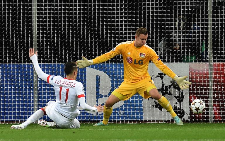 Monaco's Lucas Ocampos scores against Leverkusen's goalkeeper Bernd Leno during their UEFA Champions League second leg Group C football match in Leverkusen, Germany on November 26, 2014