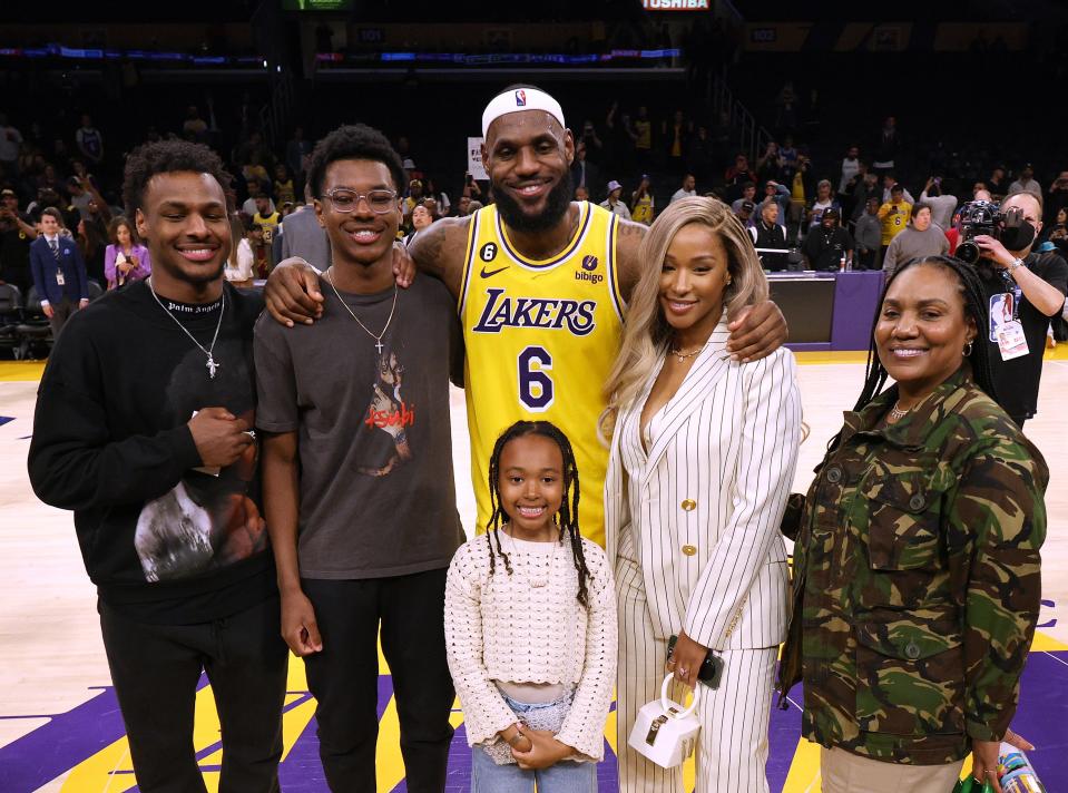 LeBron James of the Los Angeles Lakers poses for a picture with his family – from left to right: Bronny James, Bryce James, Zhuri James, Savannah James and Gloria James – at the end of the game during which James broke Kareem Abdul-Jabbar's all-time scoring record.