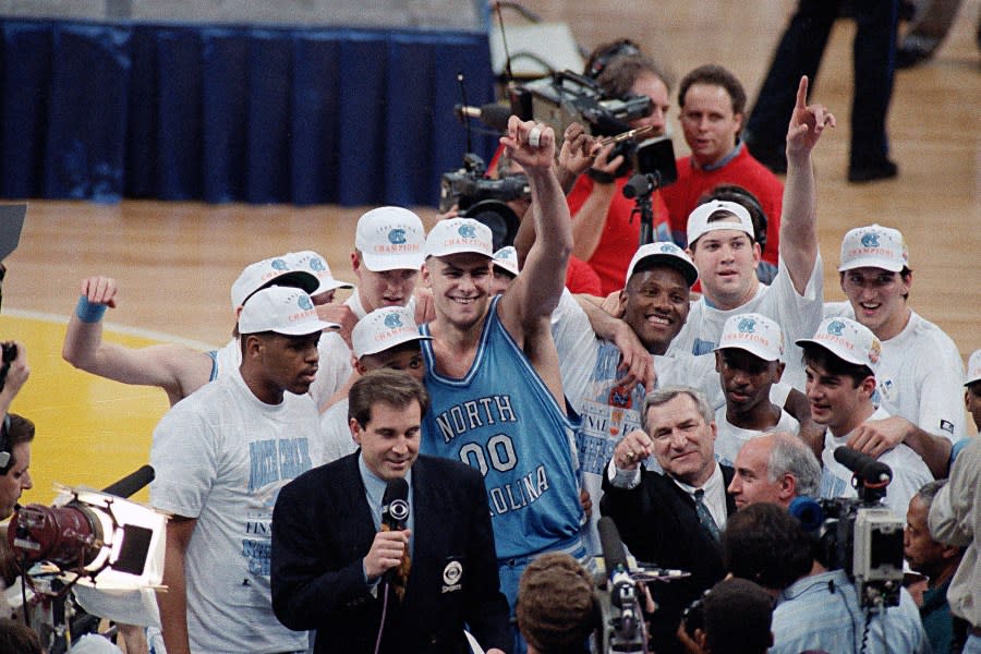 FILE – In this April 5, 1993, file photo, North Carolina’s Eric Montross (00) raises his arm as he celebrates a win against Michigan in the NCAA Final Four championship basketball game in New Orleans. The Montross family says Eric Montross has begun treatments for cancer. The family issued a statement through the school on Saturday, March 25, 2023 announcing the 51-year-old’s diagnosis, though it didn’t specify the nature of the cancer. (AP Photo/Bob Jordan, File)