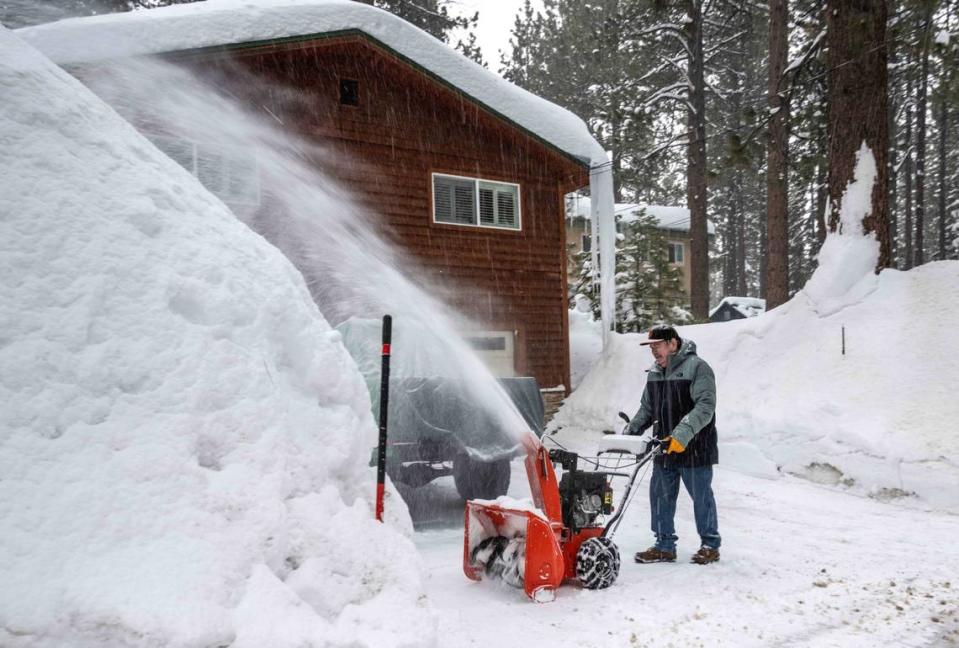 Keith Byers, a retired Fresno Police officer, removes snow from his house in South Lake Tahoe on Monday, March 6, 2023.