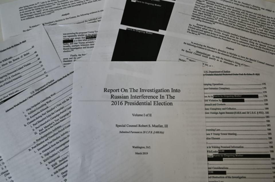 An illustration shows printed pages of the redacted Mueller Report at an office on April 18, 2019, in Washington, D.C. | EVA HAMBACH—AFP/Getty Images