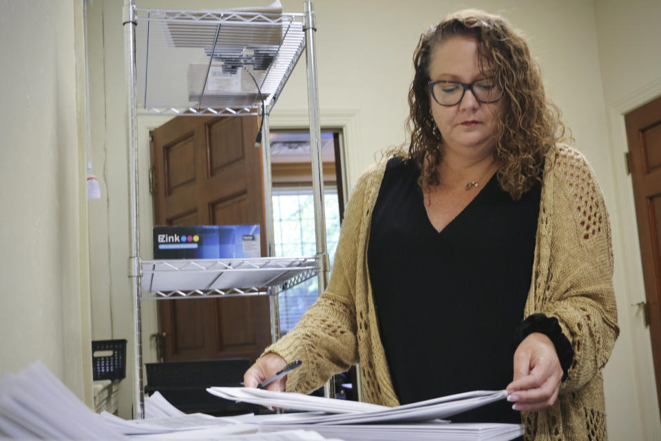 Wayne County Elections Director Anne Risku prepares absentee ballots at the Wayne County Board of Elections office on Thursday, Sept. 22, 2022, in Goldsboro, N.C. (AP Photo/Hannah Schoenbaum)