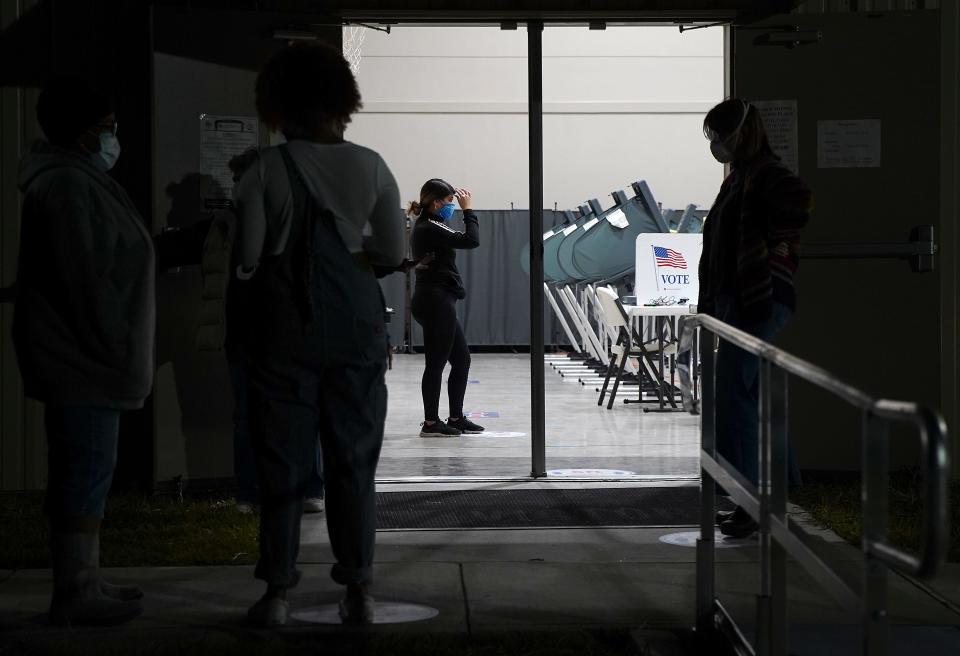 Voters wait outside Victory Houston polling station in Houston on Friday, Oct. 30, 2020. The location was one of the Harris County's 24-hour locations. ( Elizabeth Conley/Houston Chronicle via AP) ORG XMIT: TXHOU104