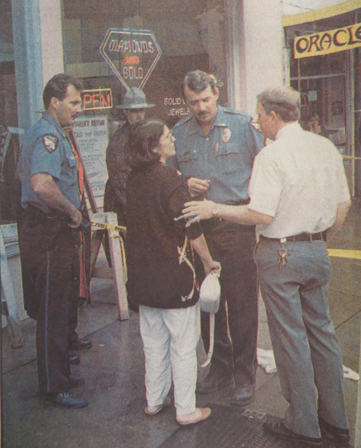 Nasrin Rouhani showed up at her husband's jewelry shop and spoke with Athens-Clarke police officers, from left, Mike Tyndell, Tim Smith and David Camp.