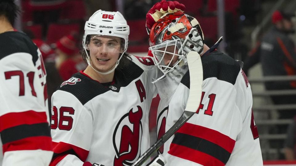 Jan 10, 2023; Raleigh, North Carolina, USA; New Jersey Devils goaltender Vitek Vanecek (41) and center Jack Hughes (86) celebrate their victory against the Carolina Hurricanes at PNC Arena