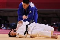 <p>Russia's Musa Mogushkov (white) and Mongolia's Tsogtbaatar Tsend-Ochir compete in the judo mixed team's quarterfinal bout during the Tokyo 2020 Olympic Games at the Nippon Budokan in Tokyo on July 31, 2021. (Photo by Jack GUEZ / AFP)</p> 