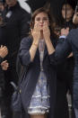 Emma Watson waves as she arrives for the Prada Fall/Winter 2024-2025 collection in Milan, northern Italy, Thursday, Feb. 22, 2024. (Claudio Furlan/LaPresse via AP)