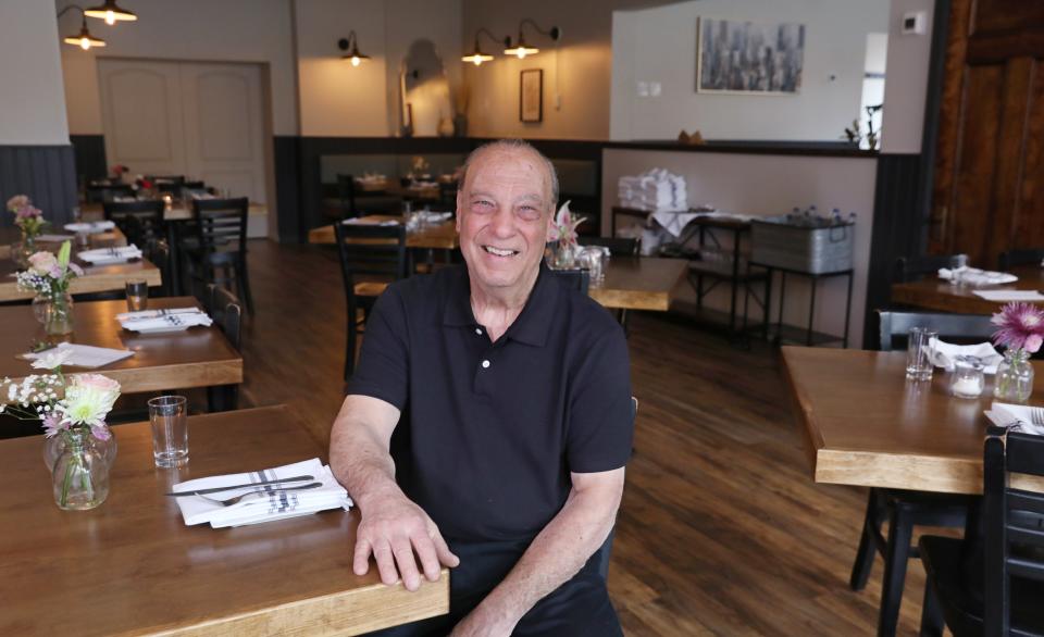 Co-owner Bob Caranddo sits for a brief moment in the main dining room before the dinnertime rush at Angelina's on South Avenue in Rochester's South Wedge Neighborhood Wednesday, May 15, 2024.
