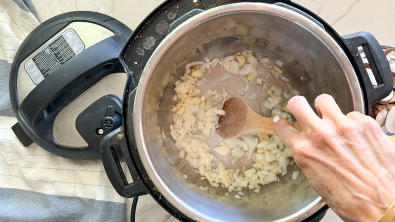 stirring onion and garlic