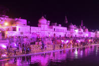 Hindu devotees gather while lighting earthen lamps on the banks of the River Sarayu on the eve before the groundbreaking ceremony of the proposed Ram Temple in Ayodhya on August 4, 2020. - India's Prime Minister Narendra Modi will lay the foundation stone for a grand Hindu temple in a highly anticipated ceremony at a holy site that was bitterly contested by Muslims, officials said. (Photo by SANJAY KANOJIA / AFP)