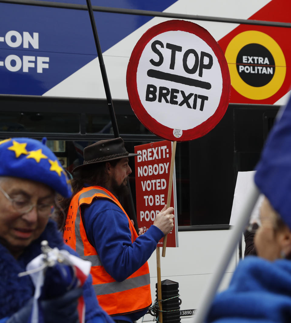 Anti-Brexit demonstrator makes his views known, outside parliament in London, Thursday Jan. 10, 2019. Prime Minister Theresa May's proposed Brexit deal seems widely disliked by both pro-Europe and pro-Brexit politicians, threatening the exit agreement and future relations with EU. (AP Photo/Alastair Grant)