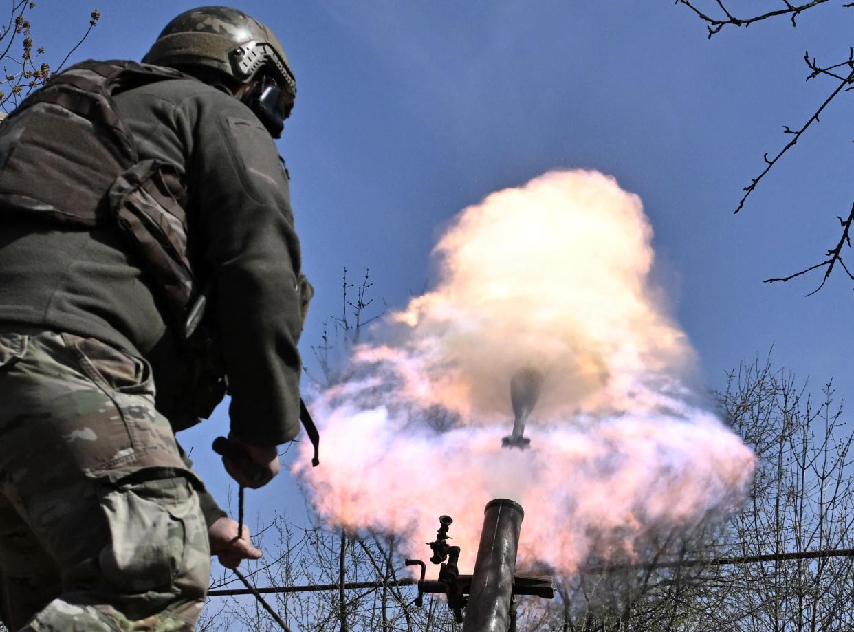 Belarusian volunteer soldiers from the Kastus Kalinouski regiment fire a mortar near Bakhmut (AFP/Getty)