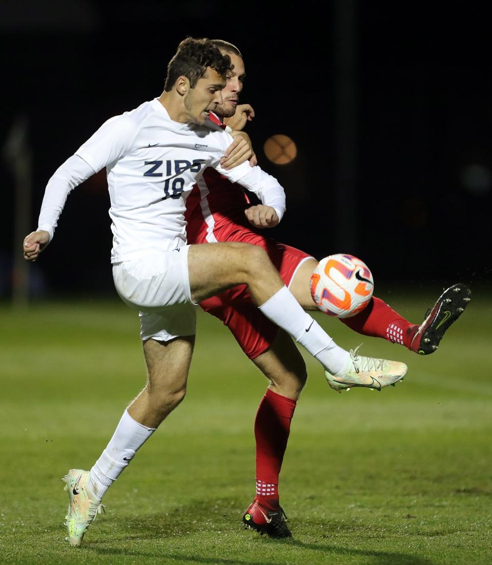 Akron forward Stefan Dobrijevic (18) attempts a shot against a Duquesne player on Sept. 28, 2022, in Akron.