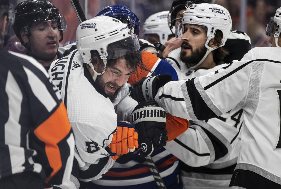 Los Angeles Kings' Drew Doughty (8) gets roughed up by the Edmonton Oilers during the second period of an NHL hockey game Thursday, March 30, 2023, in Edmonton, Alberta. (Jason Franson/The Canadian Press via AP)