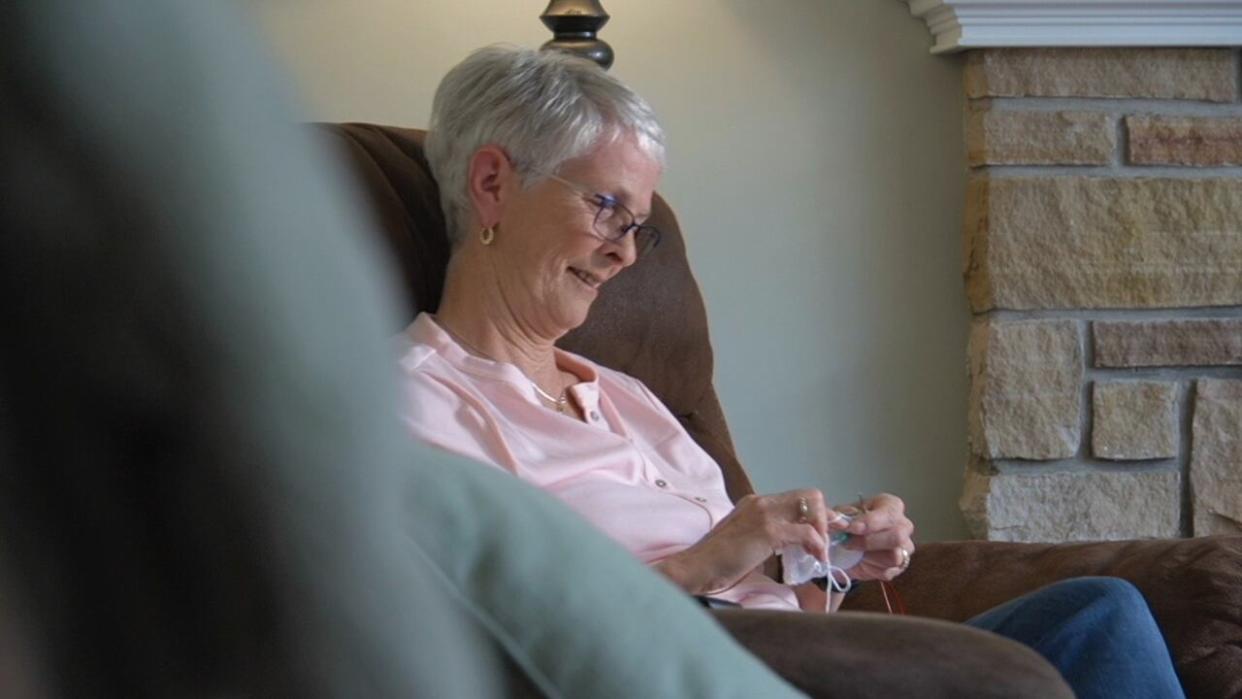 Deborah Doucet started knitting for a cause when she heard about Knitted Knockers from a friend. It allowes her to contribute to the breast cancer community, despite some of her physical limitations.  (Aniekan Etuhube/CBC - image credit)