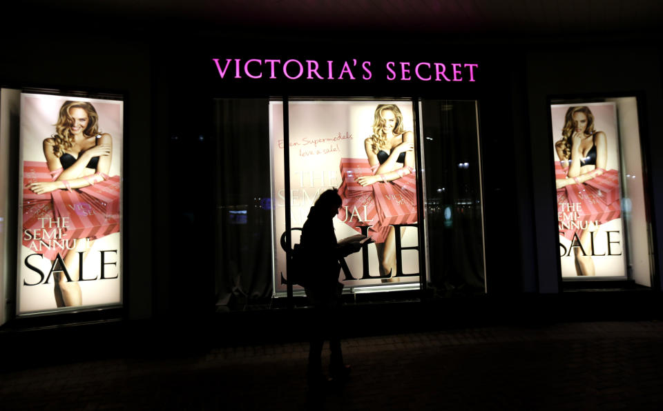 FILE - In this Thursday, Jan. 10, 2013 file photo, a woman walks in front of a Victoria's Secret store in Chicago. On Friday, July 3, 2020, The Associated Press reported on a video circulating online incorrectly asserting Victoria’s Secret clothing tags have a chip in them that tracks buyers after they purchase a product. The tiny barcode-like tag highlighted in the video is actually an ultra high frequency device used to track inventory in the store, said Justin Patton, director of a radio- frequency identification — RFID — lab at Auburn University. It isn’t functional outside the range of in-store RFID readers. (AP Photo/Nam Y. Huh)