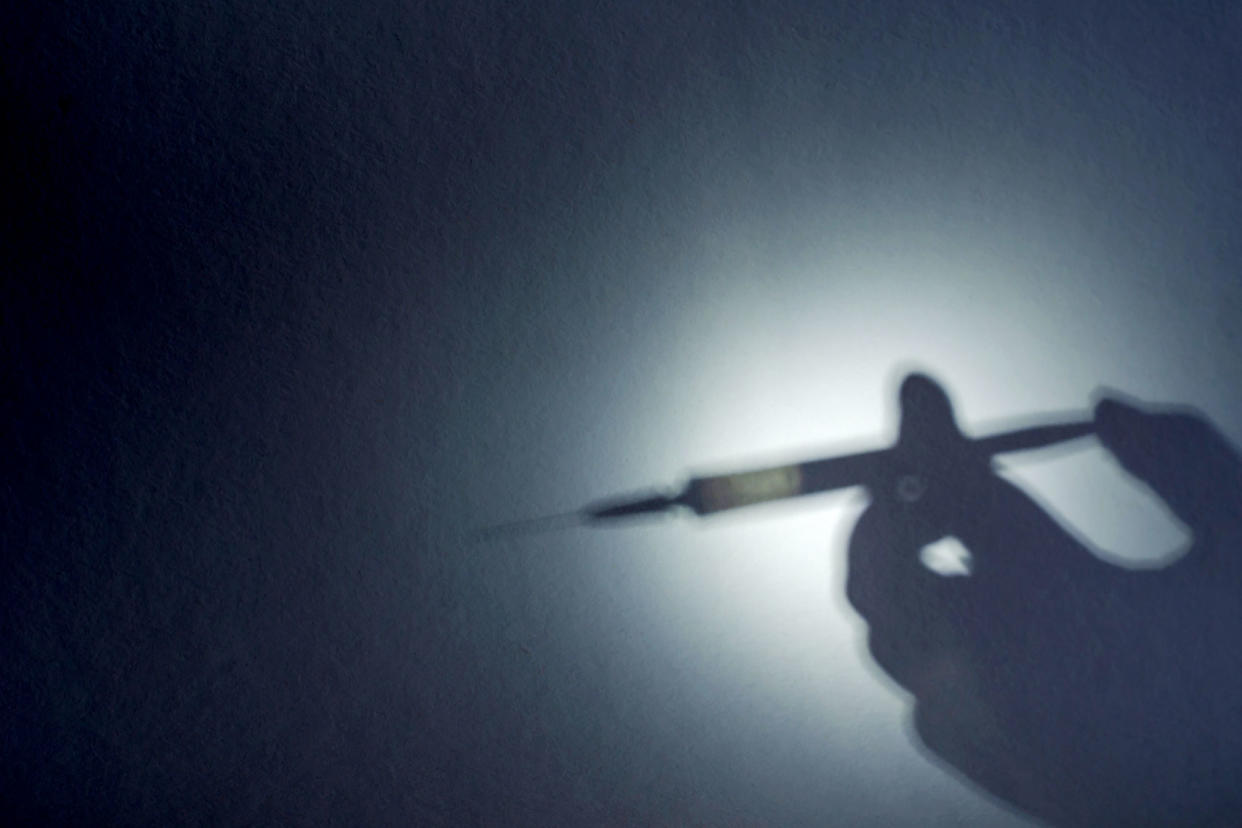 The shadow of a hand with a syringe Getty Images/Mikhail Dmitriev