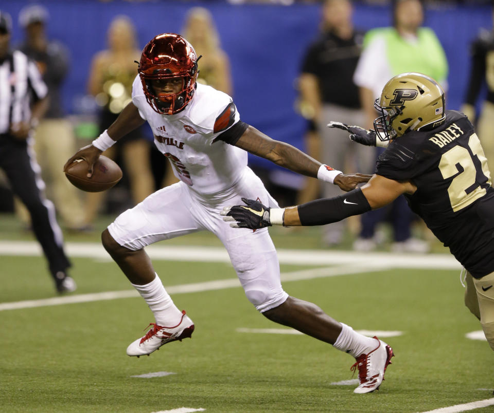 Louisville quarterback Lamar Jackson (8) gets away from Purdue linebacker Markus Bailey (21) during the first half of an NCAA college football game in Indianapolis, Saturday, Sept. 2, 2017. (AP Photo/Michael Conroy)