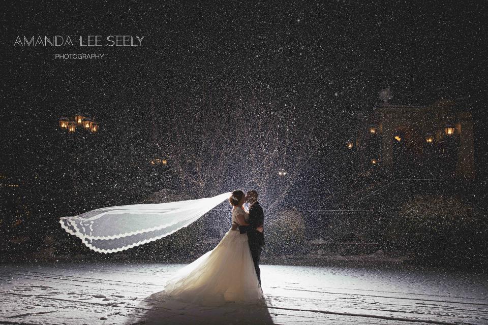 "There was no snow in the forecast but a couple minutes before the first look, it started snowing and didn't stop all day! Jenny and Jeremy's dream come true!"&mdash;<i>Amanda-Lee Seely Photography</i>