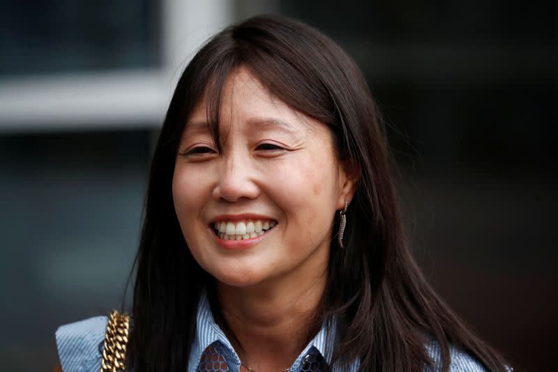 Kara Bos, whose Korean name is Kang Mee-sook when she was adopted in 1984 and is now seeking her biological parents, poses for photographs after attending her trial in front of a court in Seoul