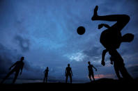 <p>A boy kicks a ball as he plays soccer with his friends at Galle Dutch Fort in Galle, Sri Lanka May 19, 2017. (Photo: Dinuka Liyanawatte/Reuters) </p>