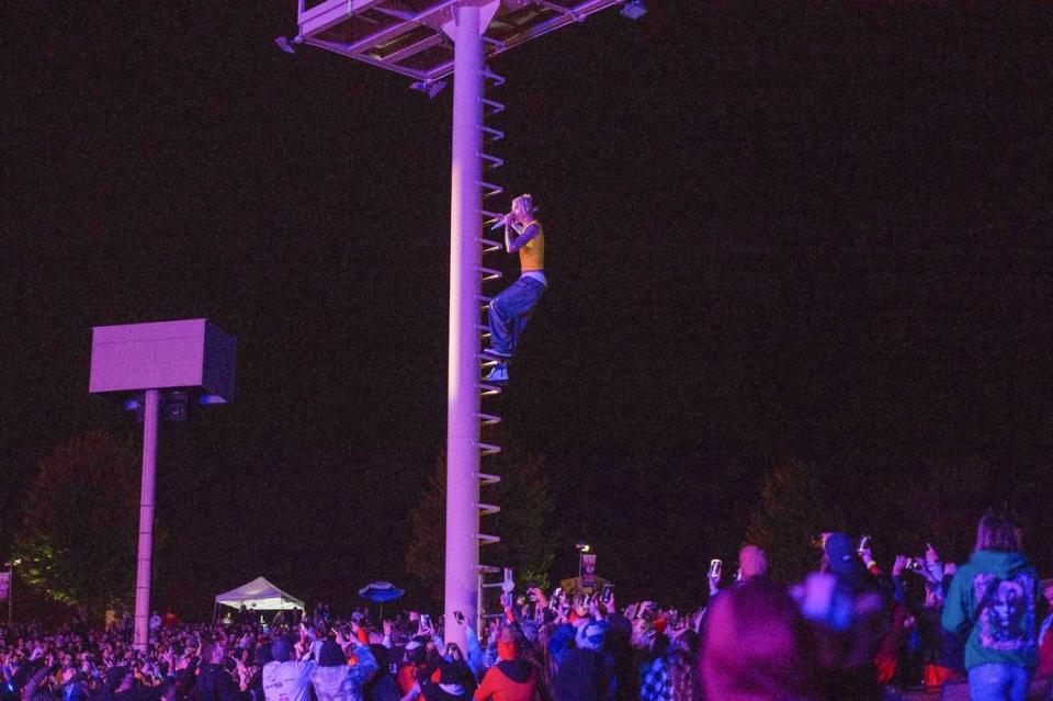 Machine Gun Kelly climbs the light tower while performing at Kelce Jam at the Azura Amphitheater on Friday, April 28, 2023, in Bonner Springs.