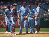 Philadelphia Phillies' Jake Arrieta, center, looks on with his teammates as he waits to be pulled from the game during the fifth inning of a baseball game against the San Francisco Giants, Thursday, Aug. 1, 2019, in Philadelphia. (AP Photo/Chris Szagola)
