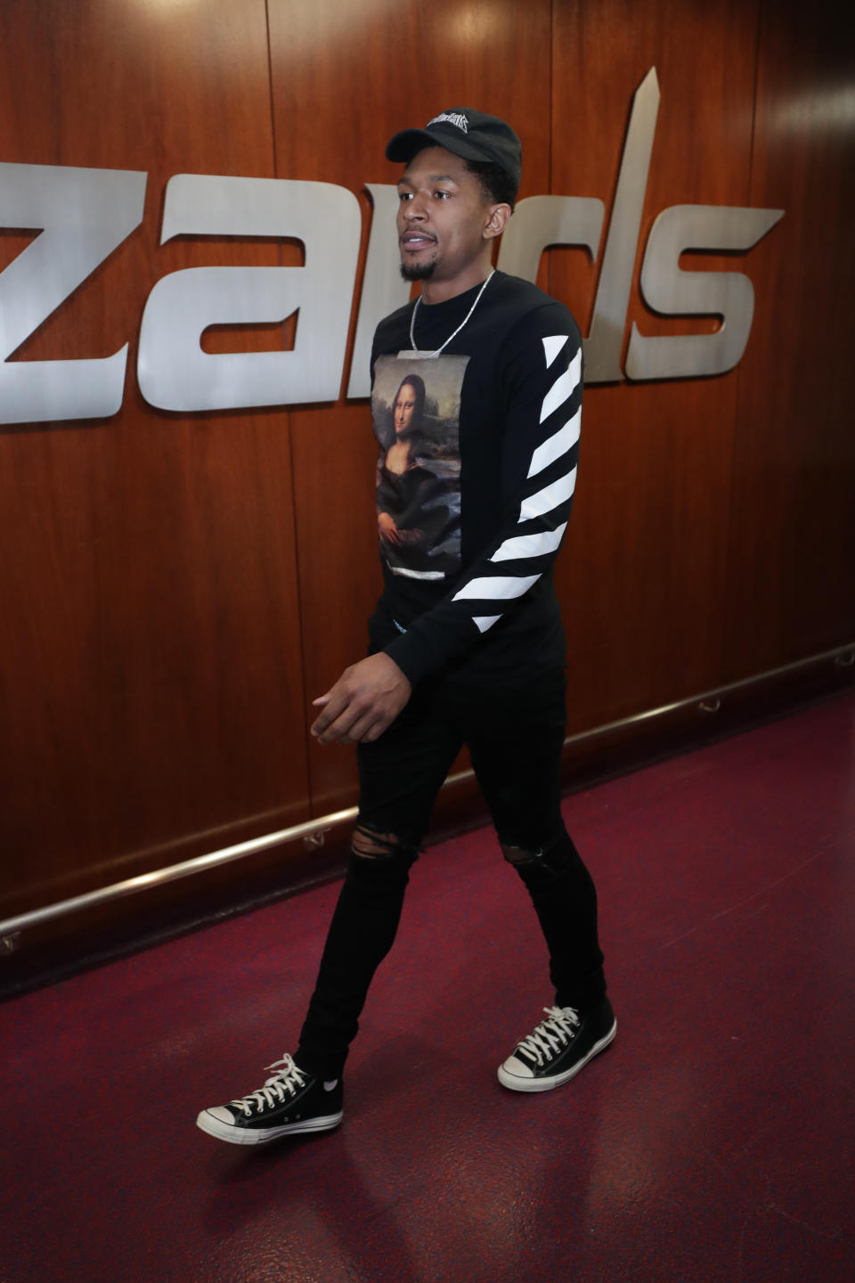 <p>Bradley Beal wears the Off-White Mona Lisa long sleeve with a pair of black high top Chucks before the Wizards, Bulls game on April 3. </p>