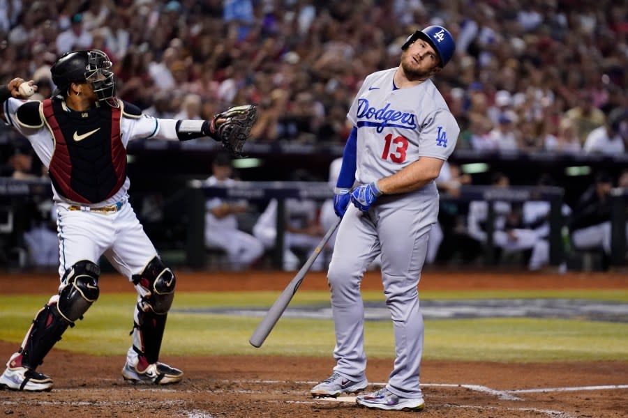 Los Angeles Dodgers’ Max Muncy (13) reacts after a foul tip was caught by Arizona Diamondbacks catcher <span class="caas-xray-inline-tooltip"><span class="caas-xray-inline caas-xray-entity caas-xray-pill rapid-nonanchor-lt" data-entity-id="Gabriel_Moreno" data-ylk="cid:Gabriel_Moreno;pos:1;elmt:wiki;sec:pill-inline-entity;elm:pill-inline-text;itc:1;cat:Athlete;" tabindex="0" aria-haspopup="dialog"><a href="https://search.yahoo.com/search?p=Gabriel%20Moreno" data-i13n="cid:Gabriel_Moreno;pos:1;elmt:wiki;sec:pill-inline-entity;elm:pill-inline-text;itc:1;cat:Athlete;" tabindex="-1" data-ylk="slk:Gabriel Moreno;cid:Gabriel_Moreno;pos:1;elmt:wiki;sec:pill-inline-entity;elm:pill-inline-text;itc:1;cat:Athlete;" class="link ">Gabriel Moreno</a></span></span>, left, during the fourth inning in Game 3 of a baseball NL Division Series, Wednesday, Oct. 11, 2023, in Phoenix. (AP Photo/Ross D. Franklin)