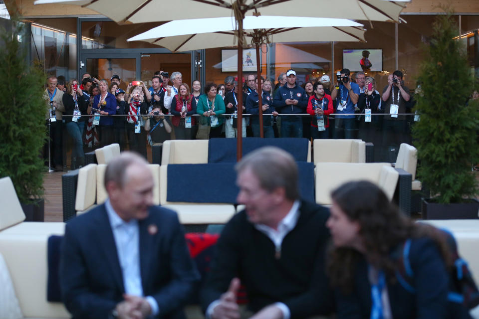  A crowd at the USA House watch as Russian President Vladimir Putin and U.S. Olympic Committee chairman Larry Probst visit USA House in the Olympic Village on February 14, 2014 in Sochi, Russia.  