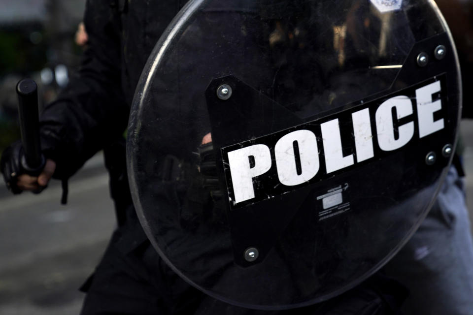 FILE - In this June 1, 2020, file photo, an officer holds a baton and shield as demonstrators gather to protest near the White House in Washington. Police departments big and small have been plagued for years by foreign hackers breaking into networks and causing varying level of mischief, from disabling email systems to more serious problems with 911 centers temporarily knocked offline. (AP Photo/Evan Vucci, File)