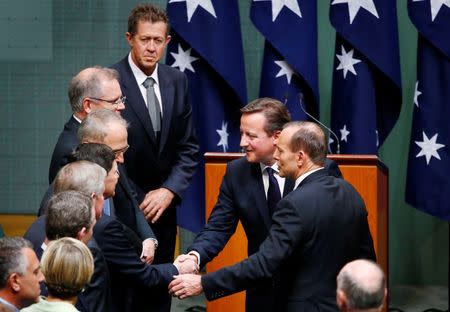 Australia's Prime Minister Tony Abbott (2nd R) introduces British Prime Minister David Cameron (3rd R) to members of his cabinet in Australia's House of Representatives chamber, after Cameron addressed a joint session of the Australian Parliament in Canberra November 14, 2014. REUTERS/David Gray