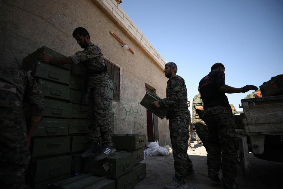 SDF fighters unload boxes of ammunition