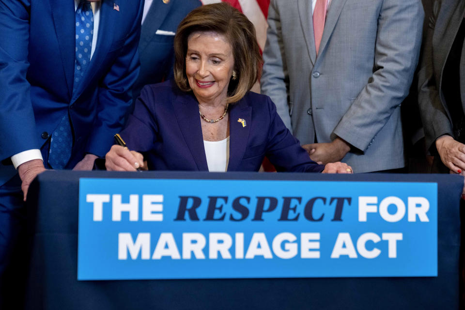 House Speaker Nancy Pelosi of Calif. signs the H.R. 8404, the Respect For Marriage Act, on Capitol Hill in Washington, Thursday, Dec. 8, 2022. (AP Photo/Andrew Harnik)