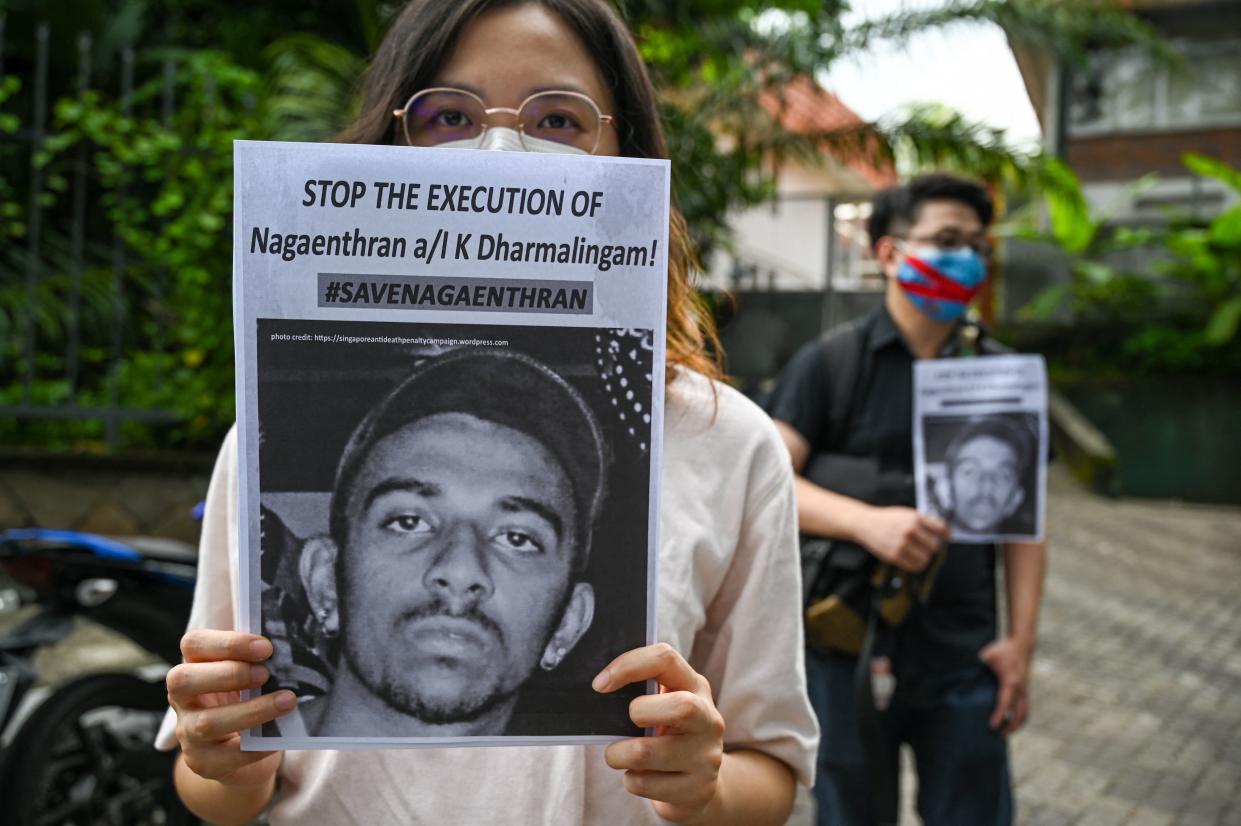 Activists hold placards before submitting a memorandum to parliament in protest at the impending execution of Nagaenthran K. Dharmalingam, sentenced to death for trafficking heroin into Singapore, in Kuala Lumpur on November 3, 2021. (Photo by Mohd RASFAN / AFP) (Photo by MOHD RASFAN/AFP via Getty Images)