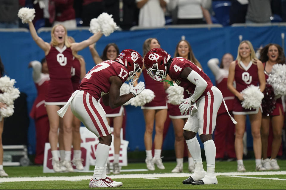 Oklahoma wide receiver Marvin Mims (17) celebrates his touchdown with Mario Williams (4) during the first half of the Alamo Bowl NCAA college football game against Oregon, Wednesday, Dec. 29, 2021, in San Antonio. (AP Photo/Eric Gay)